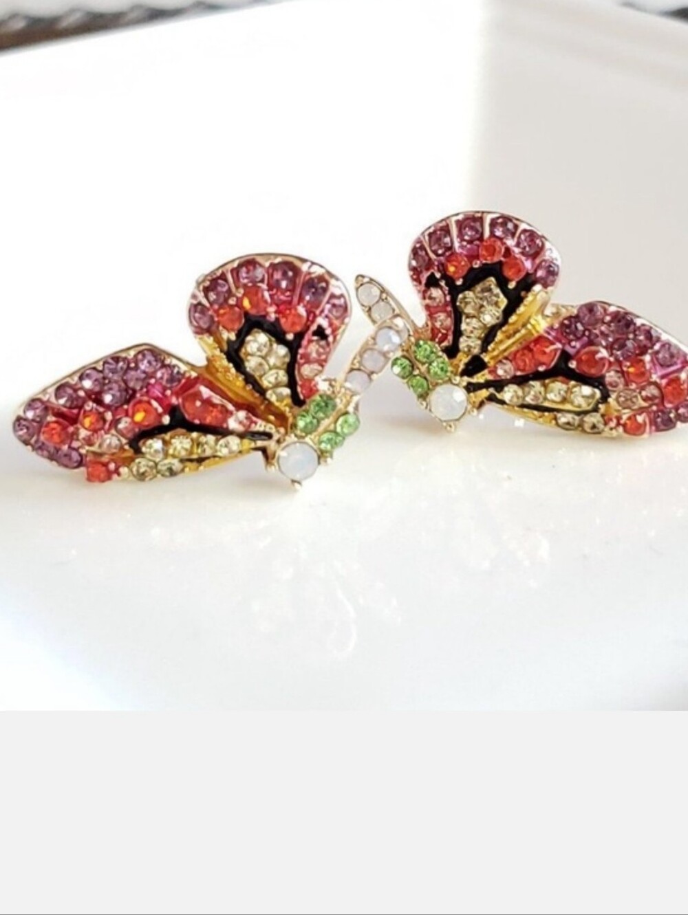 Multi-colored crystal butterfly stud earrings in pink tones; nwot